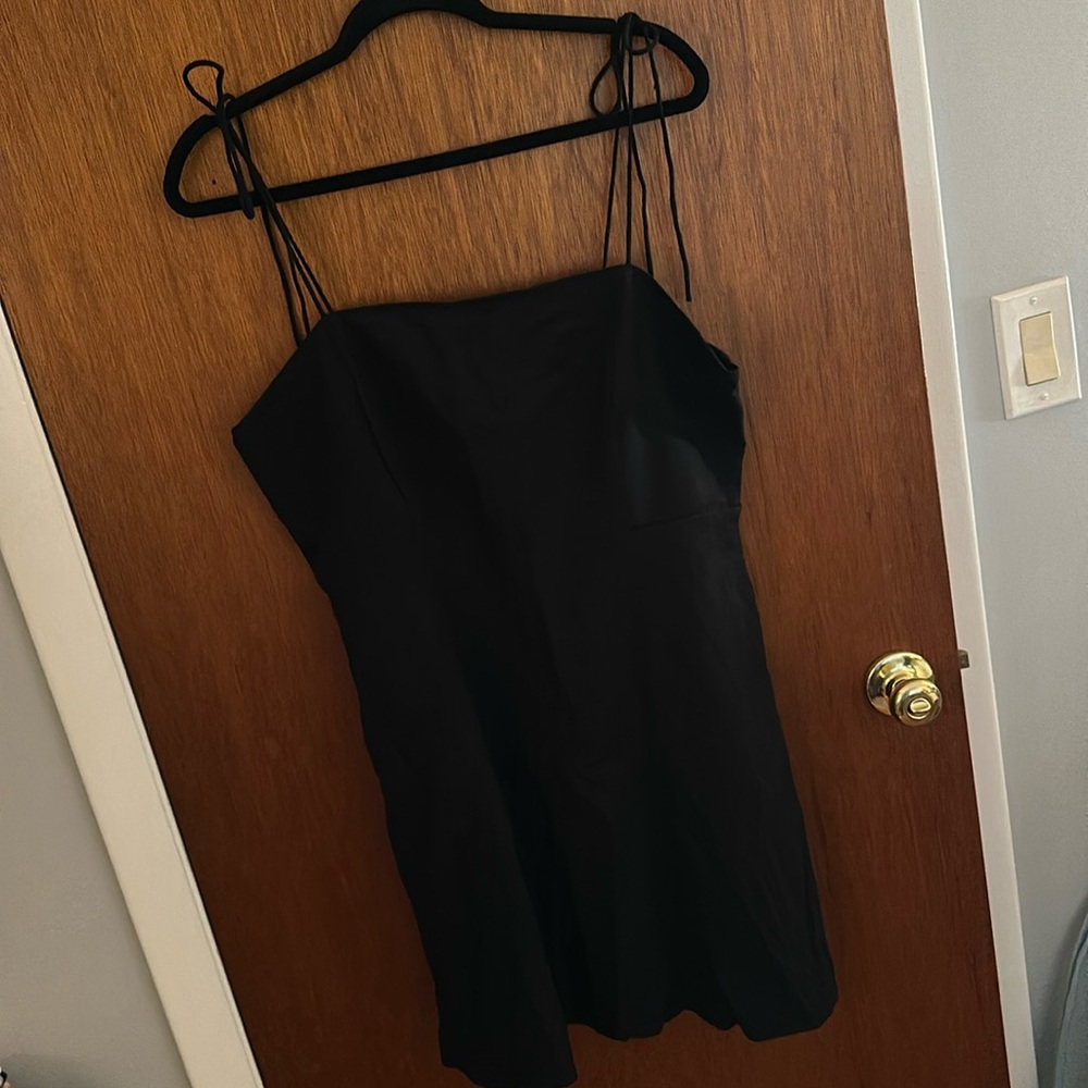 Black linen dress with tie strings, pockets, and smocked backing. Old navy